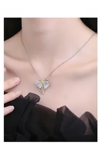 Close-up of s925 silver skirt pendant with two-tone gold finish and sparkling zircons