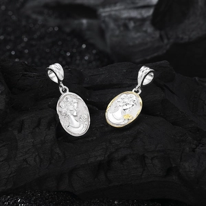 S925 sterling silver mermaid cameo pendants with gold trim on black textured background