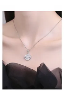 Close-up of S925 silver lace pendant with white agate and zircon on a model's neck