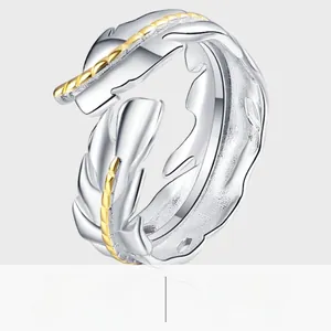 Macro detail of bicolored feather leaf ring with silver and gold plating textures