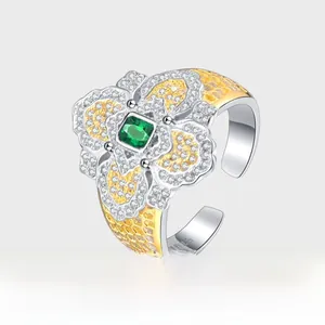 Detailed close-up of S925 sterling silver stamp on a two-tone floral vintage emerald ring