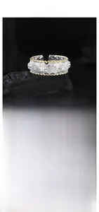 Macro shot of S925 silver vintage ring with golden wavy edges and brushed star textures