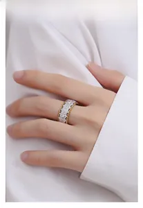Detailed macro view of retro brushed silver ring with gold edges on hand