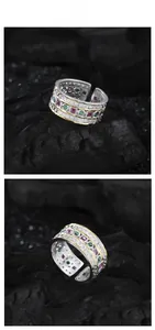 Macro detail of triple layer S925 silver ring with emerald and purple zircon inlay