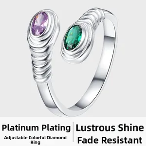 Macro shot of silver adjustable ring with purple and green oval crystal stones