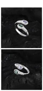 Macro view of adjustable S925 silver ring featuring purple and green oval gemstones