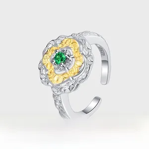 Detailed macro of S925 silver retro ring with green gemstone and gold plating