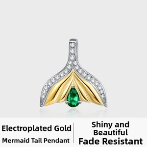 Macro detail of S925 silver mermaid tail pendant with emerald zircon and gold plating