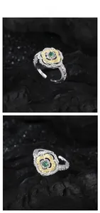 Detail of vintage S925 silver ring with green stone and golden floral relief pattern