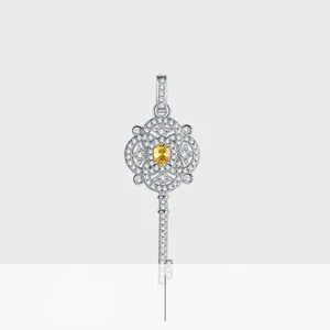 Detailed close-up of S925 silver key pendant with yellow gemstone and white diamonds