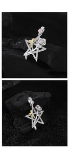 Macro detail of gothic S925 silver star rose pendant with pink zircon and gold accents