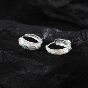 S925 silver vintage embossed floral earrings with emerald green zircon on charcoal background