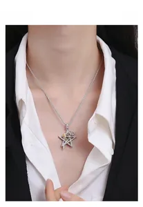 Detail of S925 silver star pendant with rose gold accents and pavé diamond stones