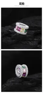 Macro detail of S925 silver pendant with colorful square cubic zirconia on dark stone