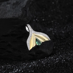 S925 silver mermaid tail pendant with emerald zircon and gold accents on charcoal