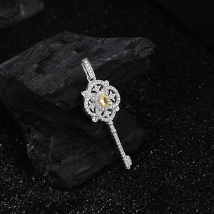 S925 silver key necklace with yellow gemstone and floral pattern on dark charcoal background