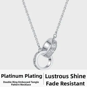 Macro view of interlocking silver rings with floral relief and screw motif detail