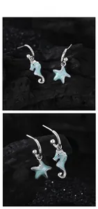 Detailed view of S925 silver asymmetric earrings featuring seahorse and starfish motifs
