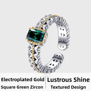Detail of square green zircon ring with gold beaded lace edges and silver band