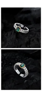 Macro detail of emerald-cut green stone ring with ornate leaf-engraved silver band