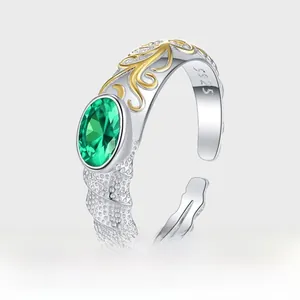Close-up of S925 sterling silver ring with green zircon and vintage golden floral textures