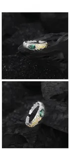 Detail of S925 silver ring featuring gold vine texture and oval green zircon stone
