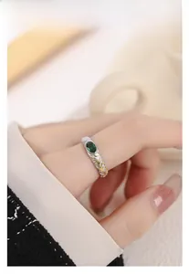 Detailed close-up of a two-tone S925 silver ring featuring a green zircon gemstone