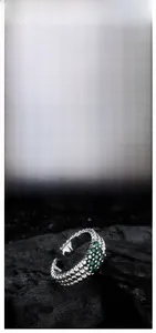 Detail of S925 sterling silver ring with green cubic zirconia and triple-row beads