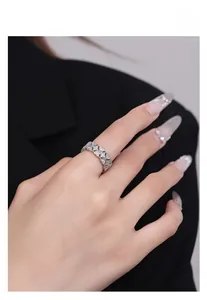Macro shot of S925 sterling silver hollow geometric ring with shimmering pavé diamond texture