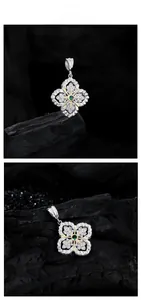 Macro shot of silver snowflake pendant with green gemstone and white zircon accents
