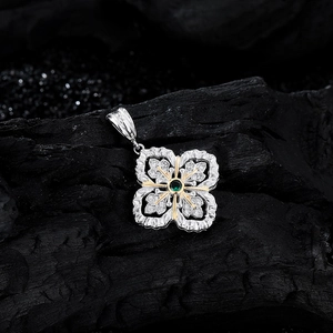 Vintage S925 sterling silver snowflake pendant with emerald green stone and gold accents