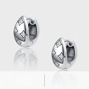 Detailed view of vintage S925 sterling silver hoop earrings with engraved star patterns
