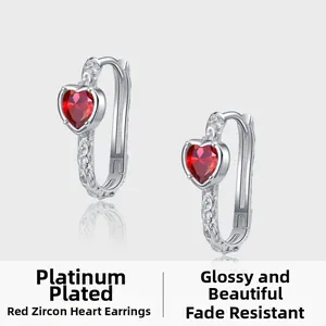 Detail of S925 silver U-shape hoop earrings with red heart zircon and floral relief