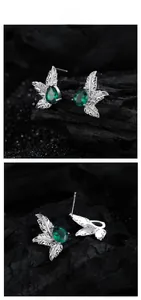 Detailed macro view of S925 sterling silver leaf earrings with green pear-cut stones