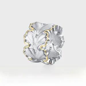 Macro detail of S925 sterling silver ginkgo leaf pendant with gold-plated edges