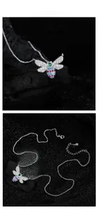 Macro detail of S925 silver bee necklace with colorful gems and sparkling zircon wings
