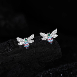 S925 silver butterfly earrings with colorful zircon stones on a dark textured base