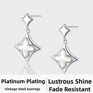 Detail of vintage sterling silver four-leaf clover earrings with white shell inlay