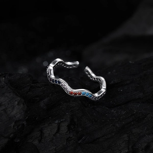 Elegant wave-shaped 925 sterling silver ring with colorful zircons on charcoal background
