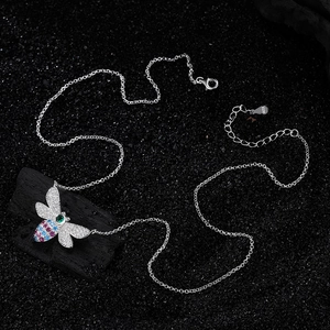 S925 sterling silver bee necklace with colorful crystals on a black charcoal background