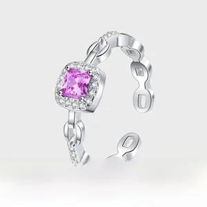 Detailed close-up of a silver ring with square purple zircon and hollow chain link band