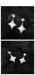 Macro detail of silver four-pointed star earrings with white shell clover inlays