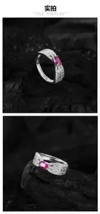 Macro detail of S925 sterling silver ring with garnet gemstone and feather pavé setting