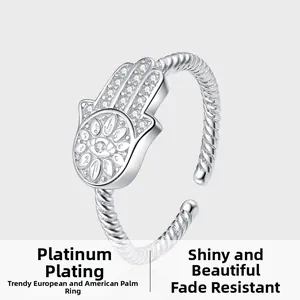 Macro detail of Hamsa Hand silver ring with pavé zircon stones and twisted band
