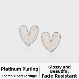 Macro detail of enamel heart earrings with marble texture and platinum-plated finish