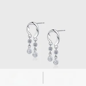 Detail of silver drop tassel earrings with white zircon stones and platinum plating