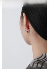 Detailed view of S925 sterling silver hoop earring with three sliding rings and blue zircon