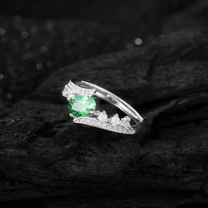 Luxurious S925 sterling silver crown ring with green oval zircon on black background
