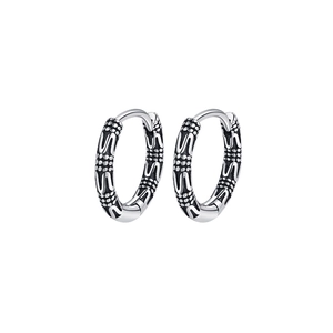 Macro detail of S925 sterling silver hoop earrings with vintage vine pattern and oxidized finish