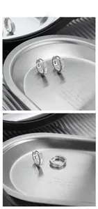 Macro view of S925 silver hoop earrings with white shell inlays and pavé zircon stones